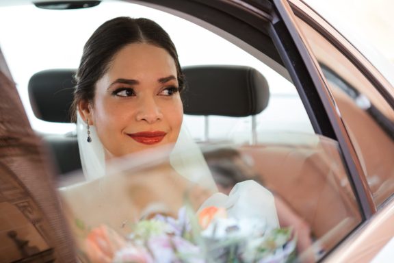Novia maquillada y peinada por estilista en Málaga en un coche